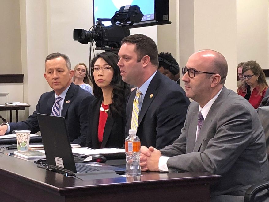 Kentucky state Rep. Michael Meredith, center, presents a proposed constitutional amendment to a House committee on Thursday, Feb. 27, 2020, in Frankfort, Ky. Meredith was joined at the table by other supporters of the measure, which cleared the committee. The proposal is aimed at giving local governments more flexibility in generating tax revenue to keep up with demands for services. (AP Photo/Bruce Schreiner)