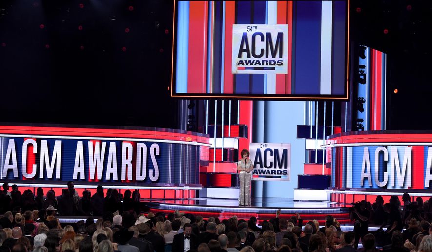 FILE - This April 7, 2019 file photo shows host Reba McEntire on stage at the 54th annual Academy of Country Music Awards in Las Vegas. The 55th annual ACM Awards will be held on Sunday, April 5. (Photo by Chris Pizzello/Invision/AP, File)