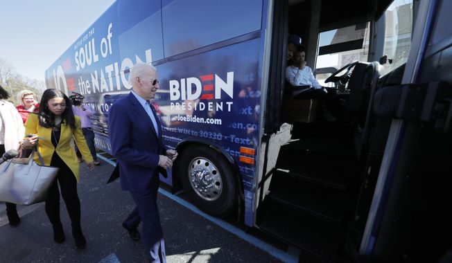 Democratic presidential candidate former Vice President Joe Biden boards his campaign bus after speaking at a campaign event in Sumter, S.C., Friday, Feb. 28, 2020. (AP Photo/Gerald Herbert)