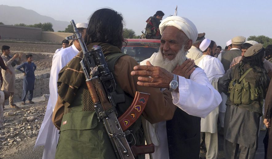 In this June 16, 2018, file photo, Taliban fighters gather with residents to celebrate a three-day cease fire marking the Islamic holiday of Eid al-Fitr, in Nangarhar province, east of Kabul, Afghanistan. Many Afghans view Saturday&#x27;s expected signing of a U.S.-Taliban peace deal with a heavy dose of well-earned skepticism. They&#x27;ve spent decades living in a country at war — some their whole lives — and wonder if they can ever reach a state of peace. (AP Photo/Rahmat Gul, File)