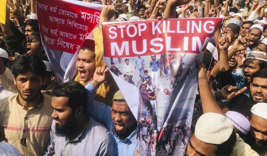 Bangladeshis protest against the communal violence in New Delhi, after Friday prayers in Dhaka, Bangladesh, Friday, Feb. 28, 2020. Authorities have not said what sparked the riots, the worst communal violence in New Delhi in decades, as the the toll continued to rise. The protestors also raised slogans against the visit of Indian Prime Minister Narendra Modi who is scheduled to visit Bangladesh in mid-March. Poster reads &amp;quot;Your religion allows the destruction of mosques, my religion prohibits destroying temples.&amp;quot; (AP Photo/Al-emrun Garjon)