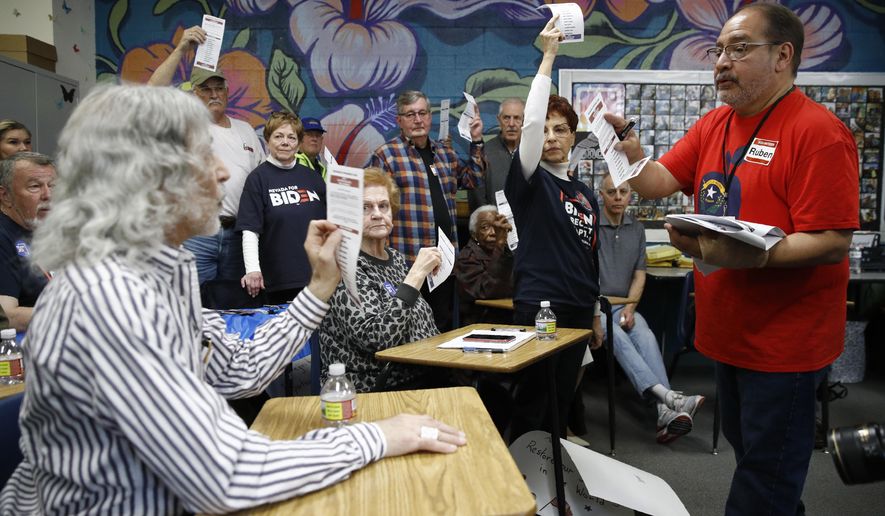 A precinct leader, right, counts votes at a caucus location at Coronado High School in Henderson, Nev., Saturday, Feb. 22, 2020. (AP Photo/Patrick Semansky)