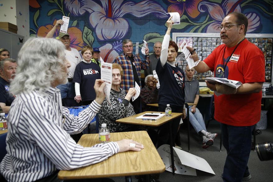 A precinct leader, right, counts votes at a caucus location at Coronado High School in Henderson, Nev., Saturday, Feb. 22, 2020. (AP Photo/Patrick Semansky)
