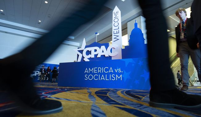People pass by the CPAC sign during Conservative Political Action Conference, CPAC 2020, at the National Harbor, in Oxon Hill, Md., Friday, Feb. 28, 2020. (AP Photo/Jose Luis Magana) **FILE**