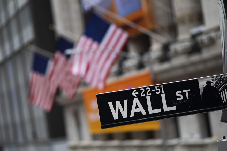 FILE - This Jan. 31, 2020, file photo shows a Wall Street sign in front of the New York Stock Exchange. Stocks plunged on Wall Street as investors feared that a virus outbreak that originated in China will dent the global economy. Investors might be on edge after the stock market surrendered five months worth of gains in an alarmingly short amount of time. A viral outbreak has spread to nearly 60 countries and shows little sign of abating. That in turn has stirred worries about the economy on a global scale. (AP Photo/Mark Lennihan, File)