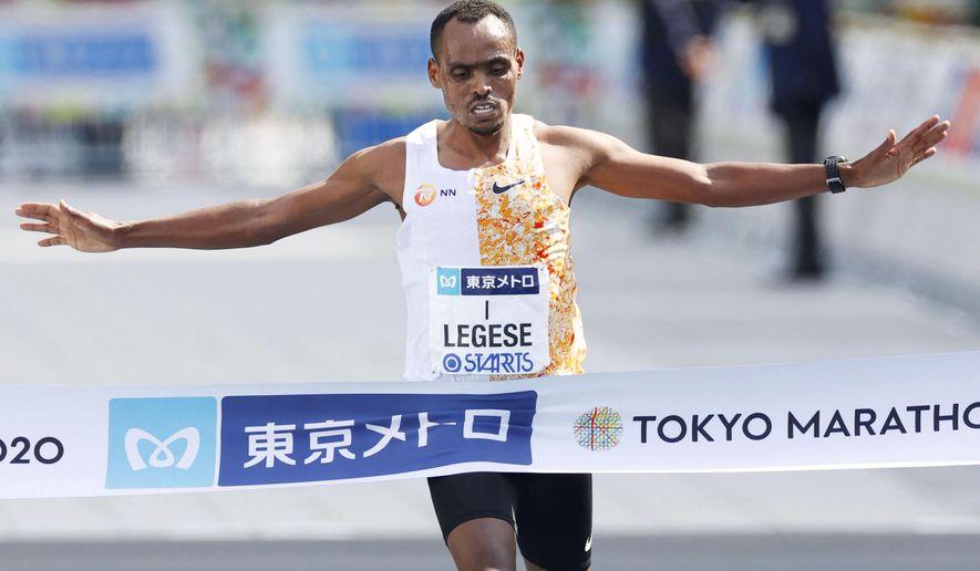 Ethiopia's Birhanu Legese crosses the finish line to win the Tokyo Marathon in Tokyo Sunday, March 1, 2020. The race was scaled back as part of Japan's efforts to combat the spread of the coronavirus. (Masanori Takei/Kyodo News via AP)