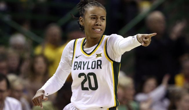 Baylor guard Juicy Landrum points to a teammate after scoring a three-point basket over Kansas State in the first half of an NCAA college basketball game, Saturday, Feb. 29, 2020, in Waco, Texas. (AP Photo/Rod Aydelotte)