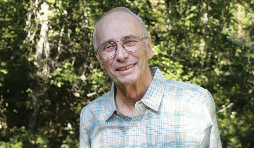 This Aug. 26, 2017 photo provided by Tom Kuglin shows his father and journalist John Kuglin posing for a photo near Swan Lake, Mont. Kuglin, a former Associated Press bureau chief for Montana and Wyoming who was a champion for open government and the public's right to know, has died, his son said Saturday, Feb. 29, 2020. He was 78. He retired from the AP in 2005. (Tom Kuglin via AP)