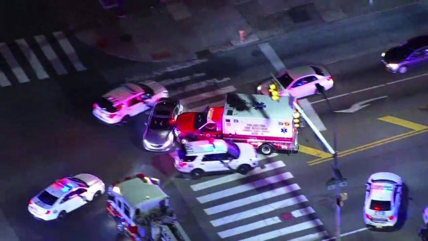 In this image made from video provided by NBC10 Philadelphia, a stolen ambulance collides with a vehicle before police officers capture a man driving the ambulance in Philadelphia on Friday, Feb. 28, 2020. The man stole the ambulance and tried to run over an officer who shot him three times, leading to a low-speed chase through Philadelphia that lasted more than an hour Friday night, authorities said. (NBC10 Philadelphia via AP) ** FILE **