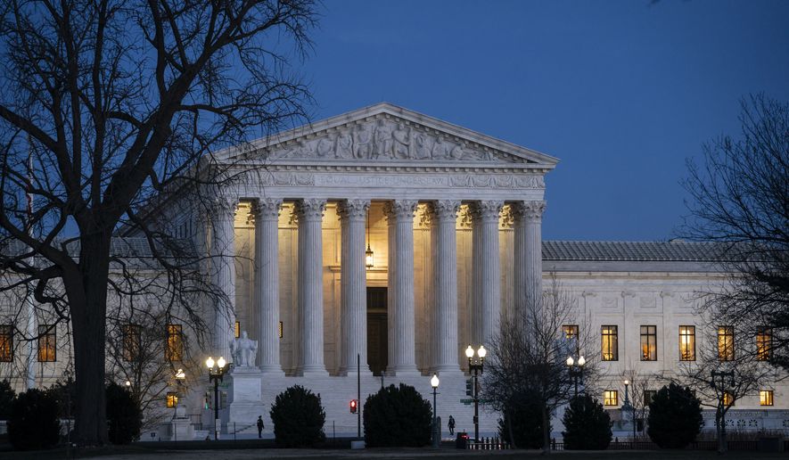 In this Jan. 22, 2020, file photo, Night falls on the Supreme Court in Washington. (AP Photo/J. Scott Applewhite, File)