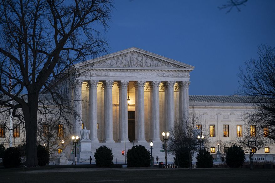In this Jan. 22, 2020, file photo, Night falls on the Supreme Court in Washington. (AP Photo/J. Scott Applewhite, File)