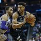Milwaukee Bucks forward Giannis Antetokounmpo, right, looks to drive against Charlotte Hornets forward P.J. Washington in the first half of an NBA basketball game in Charlotte, N.C., Sunday, March 1, 2020. (AP Photo/Nell Redmond)