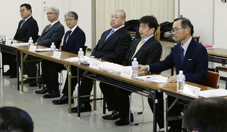Japan Sumo Association Chairman Hakkaku, fourth from left, attends an extraordinary board meeting on the next Spring Sumo Tournament in Osaka, western Japan, Sunday, March 1, 2020. On Sunday, national broadcaster NHK reported that officials of the Japan Sumo Associating decided to hold the March 8-22 spring grand sumo tournament in Osaka with no spectators. (Yosuke Mizuno/Kyodo News via AP)