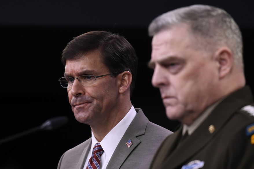 Defense Secretary Mark Esper, left, and Chairman of the Joint Chiefs of Staff Army Gen. Mark Milley, right, during a briefing at the Pentagon in Washington, Monday, March 2, 2020. (AP Photo/Susan Walsh)