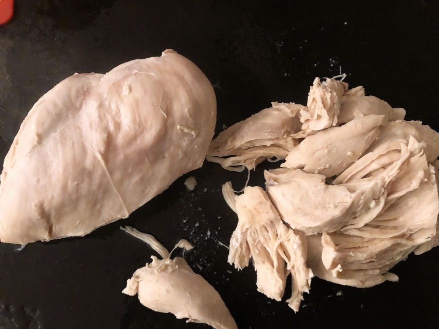 This Feb. 21, 2020 photo shows boneless chicken after it was poached in Amagansett, N.Y. You can poach your boneless, skinless chicken breasts and they will be juicy, flavorful, plump and tender. (Elizabeth Karmel via AP)