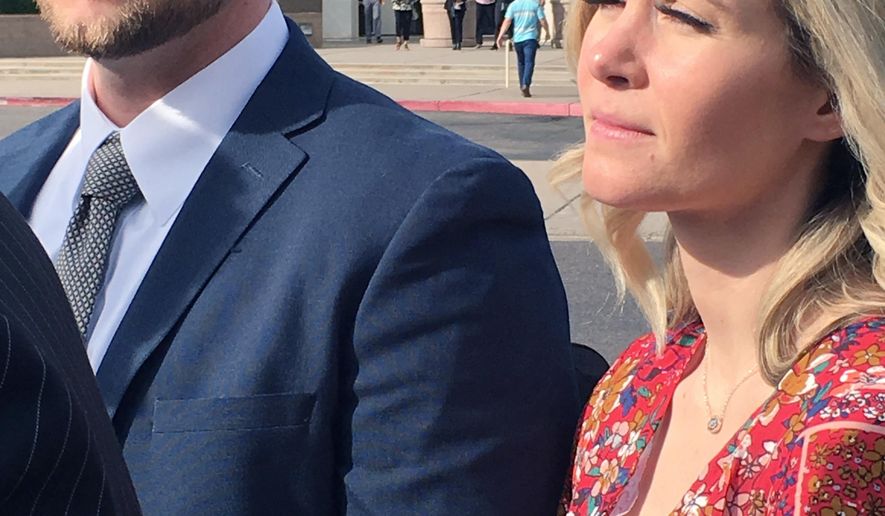 In this Feb. 27, 2020 photo Melani Pawlowski, right, is shown with her husband Ian Pawlowski outside a courthouse in Mesa, Ariz. Her ex-husband has alleged Pawlowski knows the whereabouts of two of her aunt Lori Vallow&#39;s two children, who have been missing since September. Pawlowski&#39;s lawyers denied the allegation and said their client has cooperated with authorities in the investigation. (AP Photo/Jacques Billeaud)