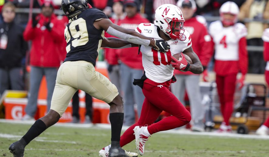FILE - In this Nov. 2, 2019, file photo, Nebraska wide receiver JD Spielman (10) holds off Purdue cornerback Simeon Smiley (29) during the second half of an NCAA college football game in West Lafayette, Ind. Spielman, a rising senior from Eden Prairie, Minnesota, who led the Cornhuskers with 49 catches for 898 yards and five touchdowns last season, has returned home to deal with a health matter and probably will miss spring practice. Coach Scott Frost didn't address the nature of Spielman's health issue. (AP Photo/Michael Conroy, File)