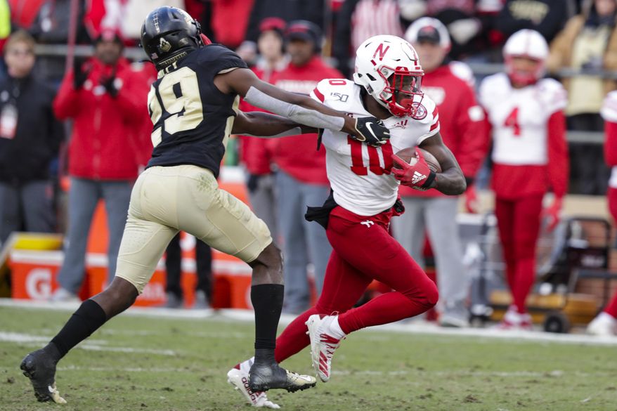FILE - In this Nov. 2, 2019, file photo, Nebraska wide receiver JD Spielman (10) holds off Purdue cornerback Simeon Smiley (29) during the second half of an NCAA college football game in West Lafayette, Ind. Spielman, a rising senior from Eden Prairie, Minnesota, who led the Cornhuskers with 49 catches for 898 yards and five touchdowns last season, has returned home to deal with a health matter and probably will miss spring practice. Coach Scott Frost didn't address the nature of Spielman's health issue. (AP Photo/Michael Conroy, File)