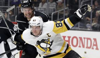 Pittsburgh Penguins&#39; Sidney Crosby, bottom, works against Los Angeles Kings&#39; Kurtis MacDermid during the third period of an NHL hockey game Wednesday, Feb. 26, 2020, in Los Angeles. (AP Photo/Marcio Jose Sanchez)