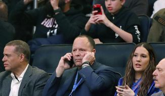 Former player agent and new New York Knicks president Leon Rose, center, takes a phone call during the first quarter of an NBA basketball game against the Houston Rockets in New York, Monday, March 2, 2020. (AP Photo/Kathy Willens)