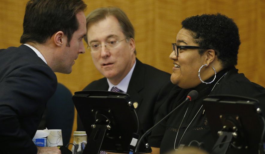 Del. Schuyler VanValkenburg, D-Henrico, left talks with Del. Marica 'Cia" Price, D-Newport News, right, as Del. Paul Krizek, D-Fairfax, center, looks on during a meeting of the House Privileges and Elections committee at the Capitol Friday, Feb. 28, 2020, in Richmond, Va. Gov. Ralph Northam is floating an alternative redistricting plan as his fellow Democrats remain deadlocked on how best to draw new congressional and legislative maps next year. (AP Photo/Steve Helber)