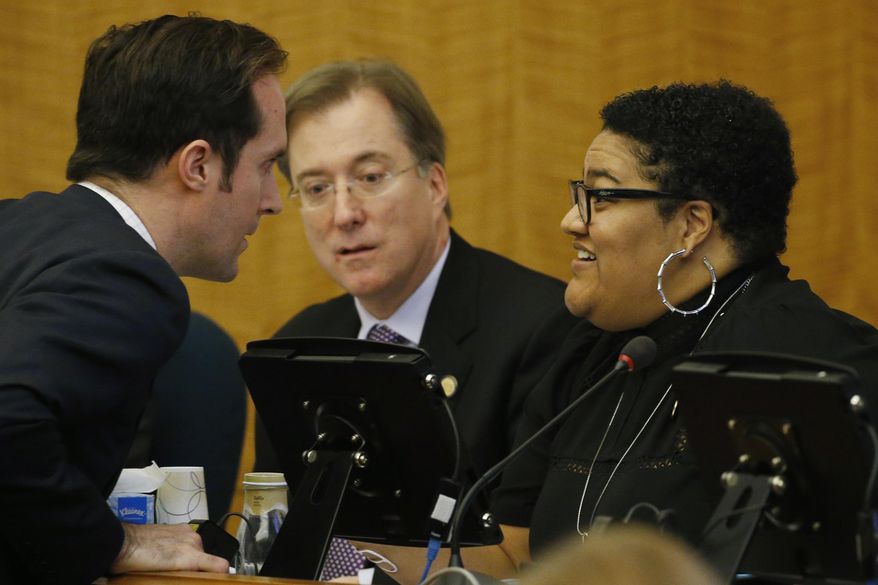 Del. Schuyler VanValkenburg, D-Henrico, left talks with Del. Marica 'Cia" Price, D-Newport News, right, as Del. Paul Krizek, D-Fairfax, center, looks on during a meeting of the House Privileges and Elections committee at the Capitol Friday, Feb. 28, 2020, in Richmond, Va. Gov. Ralph Northam is floating an alternative redistricting plan as his fellow Democrats remain deadlocked on how best to draw new congressional and legislative maps next year. (AP Photo/Steve Helber)