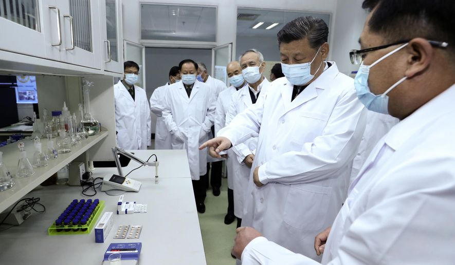 In this photo released by Xinhua News Agency, Chinese President Xi Jinping, second right, wearing a protective face mask, talks to a medical staff members during his visit to the Academy of Military Medical Sciences in Beijing, Monday, March 2, 2020. The number of new virus infections rose worldwide along with fears of a weakening global economy, even as cases in China dropped to their lowest level in six weeks on Monday and hundreds of patients at the outbreak&#39;s epicenter were released from hospitals. (Ju Peng/Xinhua via AP)