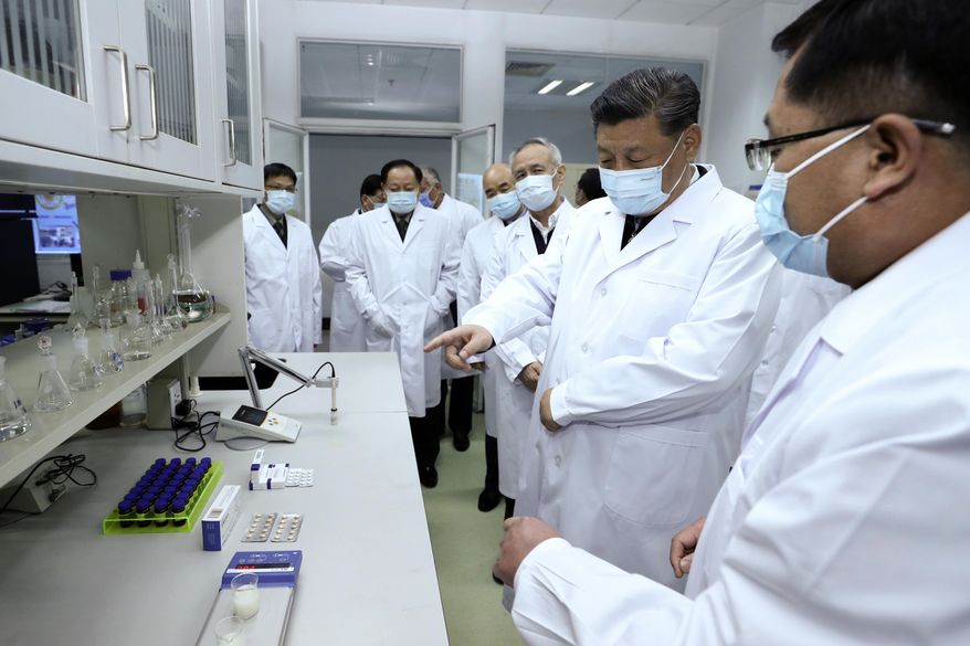 In this photo released by Xinhua News Agency, Chinese President Xi Jinping, second right, wearing a protective face mask, talks to a medical staff members during his visit to the Academy of Military Medical Sciences in Beijing, Monday, March 2, 2020. The number of new virus infections rose worldwide along with fears of a weakening global economy, even as cases in China dropped to their lowest level in six weeks on Monday and hundreds of patients at the outbreak&#x27;s epicenter were released from hospitals. (Ju Peng/Xinhua via AP)