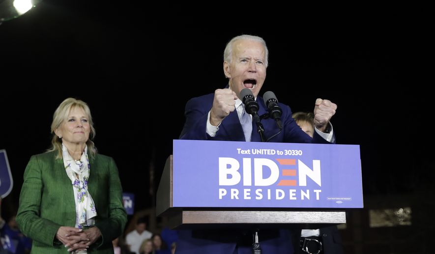 Democratic presidential candidate former Vice President Joe Biden, right, speaks next to his wife Jill during a primary election night rally Tuesday, March 3, 2020, in Los Angeles. (AP Photo/Marcio Jose Sanchez)