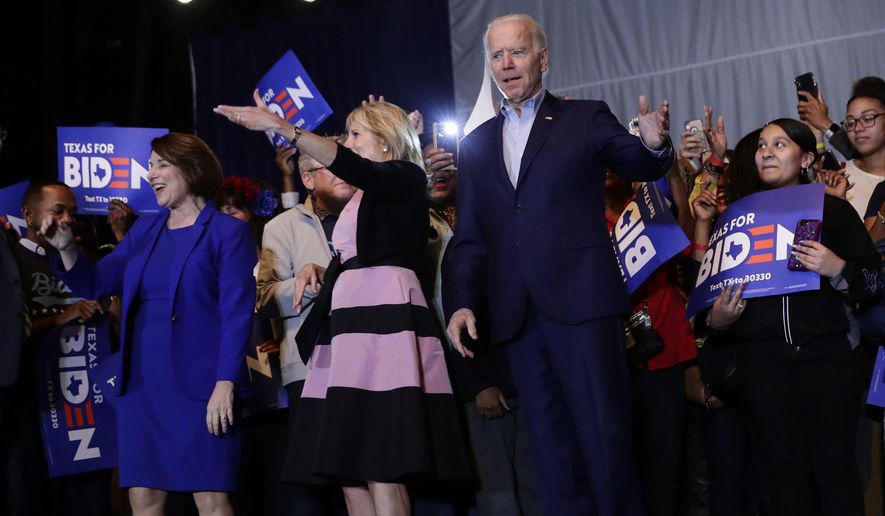 Democratic presidential candidate former Vice President Joe Biden, right, is joined by former rival Sen. Amy Klobuchar, left, during a campaign stop in Dallas, Monday, March 2, 2020. At center is Jill Biden. (AP Photo/Eric Gay)