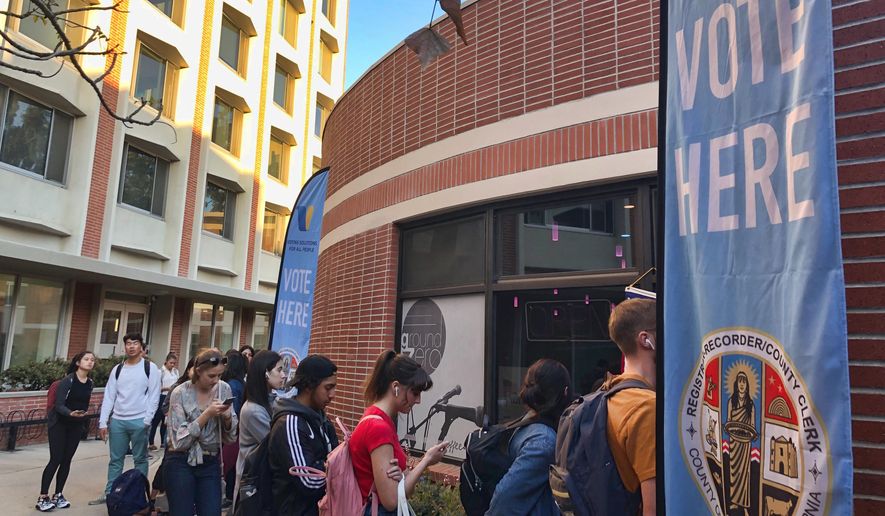 Voters wait on line at a polling station at the University of Southern California on Tuesday, March 3, 2020. Some California voters are waiting in long lines because of technical glitches connecting to the statewide voter database or too many users trying to cast ballots at once. The secretary of state's office said election workers in 15 counties could not connect to the statewide voter registration database on Super Tuesday but that the issues have been resolved. (AP Photo/Stefanie Dazio)