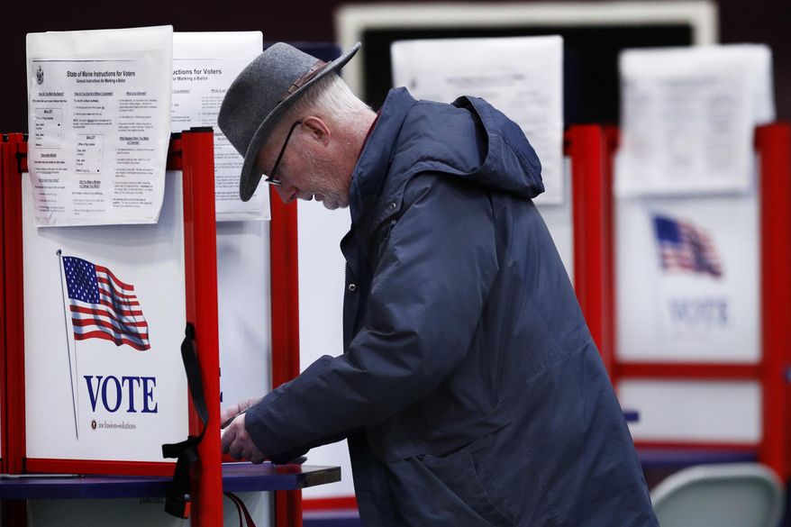 Mike Walsh votes in the primary election, Tuesday, March 3, 2020, in Freeport, Maine. (AP Photo/Robert F. Bukaty)