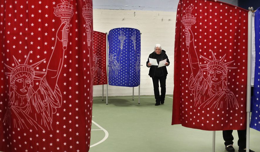 Louise Wilcox checks her ballots after coming out of a booth while voting in the primary election, Tuesday, March 3, 2020, in Mechanic Falls, Maine. (AP Photo/Robert F. Bukaty)