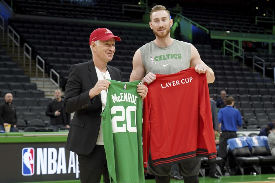 John McEnroe, Captain of Team World for the Laver Cup, trades jerseys with Boston Celtics forward Gordon Hayward before a game against the Brooklyn Nets, Tuesday, March 3, 2020, in Boston. Laver Cup 2020 will be played at the TD Garden in Boston from September 25-27. (AP Photo/Mary Schwalm)