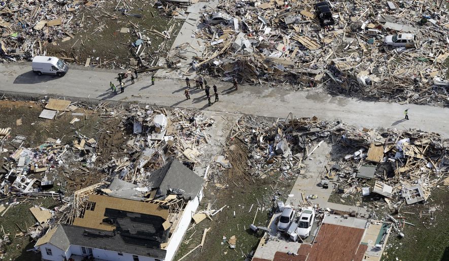 Emergency personnel work among destroyed homes Tuesday, March 3, 2020, near Cookeville, Tenn. Tornadoes ripped across Tennessee early Tuesday, shredding more than 140 buildings and burying people in piles of rubble and wrecked basements. At least 22 people were killed. (AP Photo/Mark Humphrey)