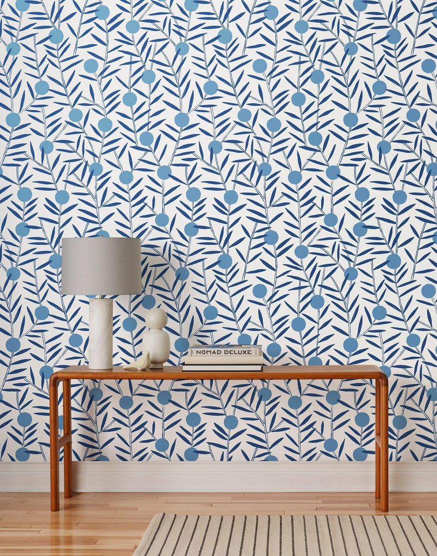 This photo provided by Hygge & West shows Bloom Wallpaper in Bluebell. In lighting fixtures, wallpapers, bedding and wall art, floral design is having a big year in 2020. There's also a renewed interest in flower arranging and floral-inspired table settings. (Hygge & West via AP)