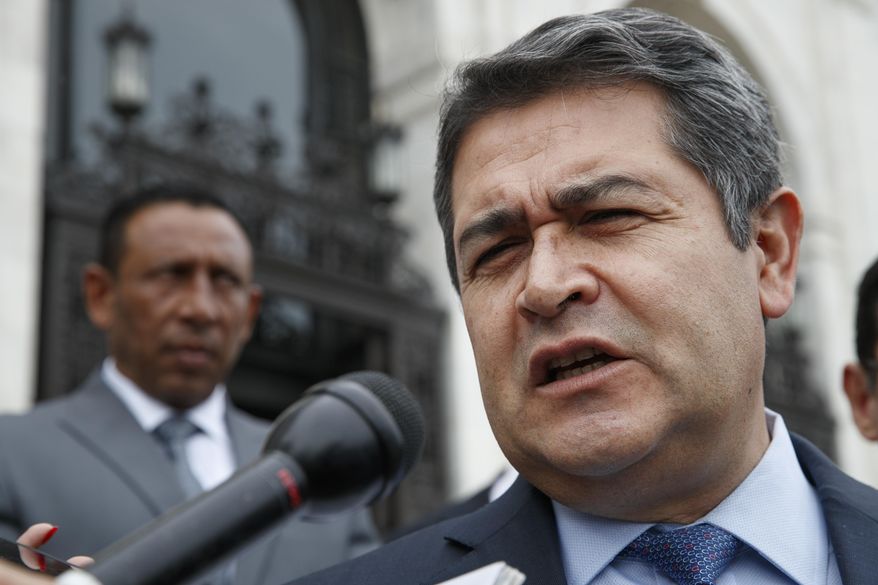 In this Aug. 13, 2019 file photo, Honduran President Juan Orlando Hernandez answers questions from the Associated Press, as he leaves a meeting at the Organization of American States, in Washington. U.S. prosecutors said on Tuesday, March 3, 2020, that Hernandez met with an Honduran drug dealer in 2013 and agreed to facilitate the use of Honduran armed forces personnel as security for the dealer’s drug trafficking activities. In 2013, Hernandez was a congressman. He was elected president at the end of that year. (AP Photo/Jacquelyn Martin, File)