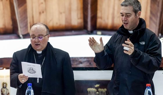 FILE - Archbishop Charles Scicluna, left, and Spanish Monsignor Jordi Bertomeu attend a meeting with the Catholic community at the Sacred Heart of Jesus church in Osorno, Chile, in this Saturday, June 16, 2018 file photo. The Vatican is sending its top two sex crimes investigators to Mexico on a fact-finding and assistance mission as the Catholic hierarchy in the world&#39;s second-largest Catholic country begins to reckon with decades of clergy sex abuse and cover-up. (AP Photo/Fernando Lavoz)