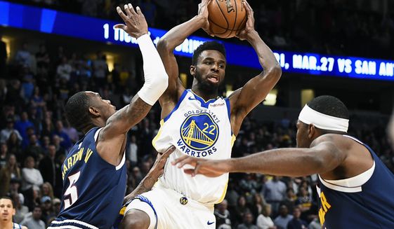 Golden State Warriors Andrew Wiggins (22) looks to make a pass as Denver Nuggets Will Baton lll (5) defends during the first half of an NBA basketball game Tuesday, March 3, 2020 in Denver (AP Photo/John Leyba)