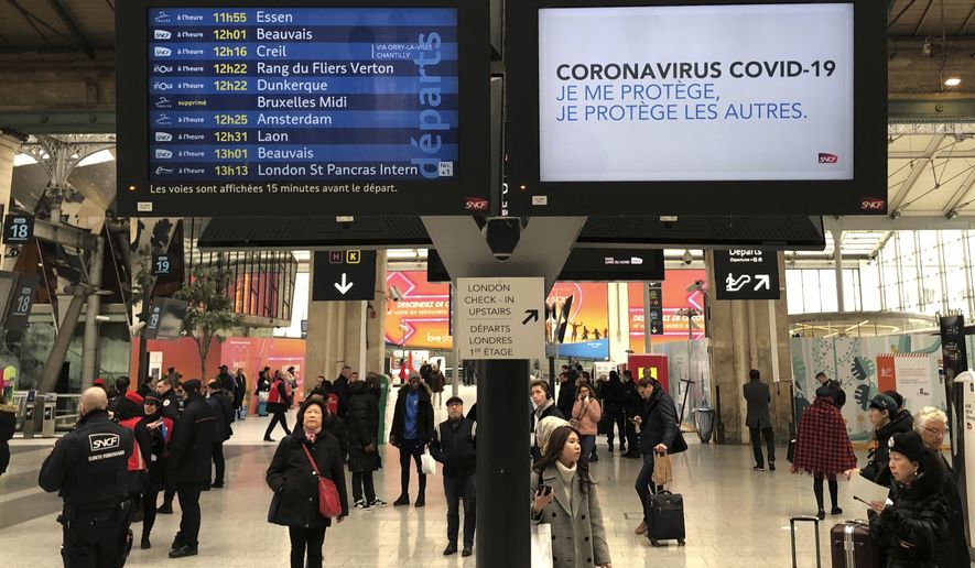A screen reads: &quot;Coronavirus COVID-19. I protect myself, I protect others&quot; at the Gare du Nord train station in Paris, Wednesday, March 4, 2020. With the COVID-19 virus taking firmer hold in Europe, the continent is facing the same complications seen in Asia weeks ago. (AP Photo/Bertrand Combaldieu)