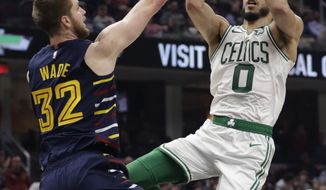 Boston Celtics&#39; Jayson Tatum (0) drives to the basket against Cleveland Cavaliers&#39; Dean Wade (32) in the first half of an NBA basketball game, Wednesday, March 4, 2020, in Cleveland. (AP Photo/Tony Dejak)