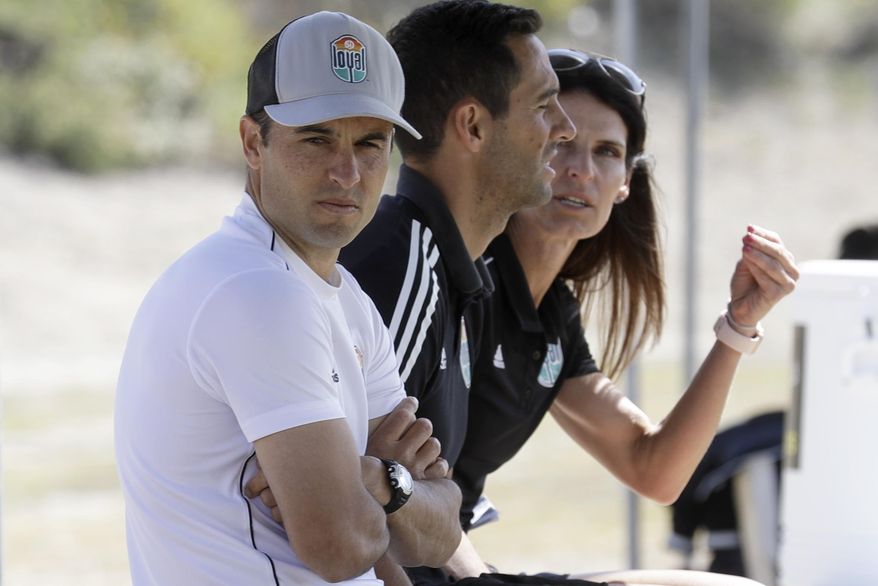Landon Donovan, left, looks on alongside assistant coaches Nate Miller, center, and Carrie Taylor, right, during a scrimmage, Wednesday, March 4, 2020 in Chula Vista, Calif. Donovan, one of the greatest U.S. soccer players of all time, has revived his passion for the game as coach of the expansion San Diego Loyal of the professional second-division United Soccer League. (AP Photo/Gregory Bull)