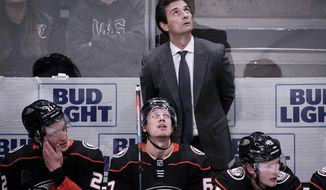 Anaheim Ducks coach Dallas Eakins watches during the third period of an NHL hockey game against the New Jersey Devils in Anaheim, Calif., Sunday, March 1, 2020. (AP Photo/Chris Carlson)