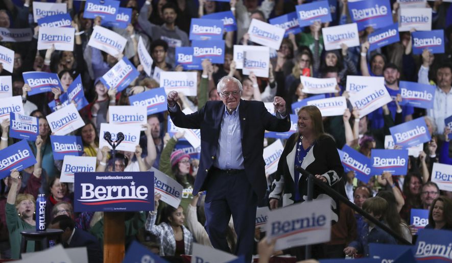 Democratic presidential candidate Sen. Bernie Sanders, I-Vt., accompanied by his wife Jane O'Meara Sanders, arrives to speak during a primary night election rally in Essex Junction, Vt., Tuesday, March 3, 2020. (AP Photo/Charles Krupa)
