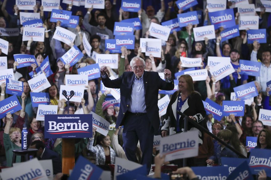 Democratic presidential candidate Sen. Bernie Sanders, I-Vt., accompanied by his wife Jane O'Meara Sanders, arrives to speak during a primary night election rally in Essex Junction, Vt., Tuesday, March 3, 2020. (AP Photo/Charles Krupa)