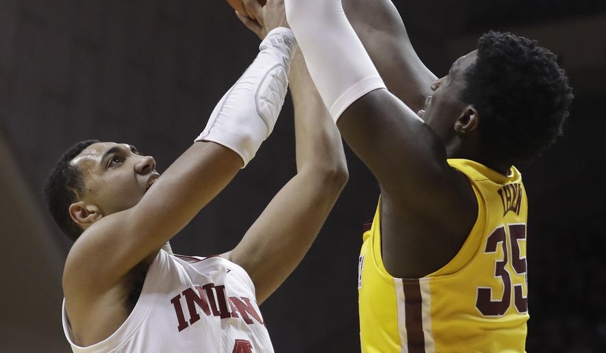 Indiana&#39;s Trayce Jackson-Davis (4) shoots against Minnesota&#39;s Isaiah Ihnen (35) during the first half of an NCAA college basketball game, Wednesday, March 4, 2020, in Bloomington, Ind. (AP Photo/Darron Cummings)