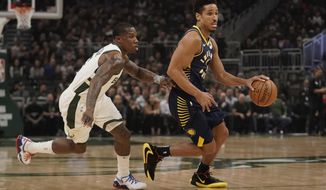 Indiana Pacers&#39; Malcolm Brogdon drives past Milwaukee Bucks&#39; Eric Bledsoe during the first half of an NBA basketball game Wednesday, March 4, 2020, in Milwaukee. (AP Photo/Morry Gash)