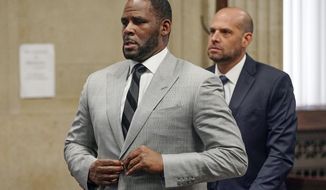 FILE - In this June 6, 2019, file photo, singer R. Kelly pleaded not guilty to 11 additional sex-related felonies during a court hearing before Judge Lawrence Flood at Leighton Criminal Court Building in Chicago. R&amp;amp;B singer R. Kelly is due in federal court to enter a plea to an updated federal indictment that includes sex abuse allegations involving a new accuser.  The 53-year-old is expected to plead not guilty at a hearing Thursday, March 5, 2020, in Chicago to a superseding indictment unsealed last month that includes multiple counts of child pornography. (E. Jason Wambsgans/Chicago Tribune via AP, Pool, File)