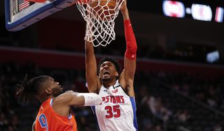 Detroit Pistons forward Christian Wood (35) dunks on Oklahoma City Thunder center Nerlens Noel (9) during the first half of an NBA basketball game in Detroit, Wednesday, March 4, 2020. (AP Photo/Paul Sancya)