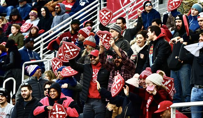 A group of football fans cheer for the DC Defenders of the XFL in the league&#x27;s inaugural game between the Defenders and the Seattle Dragons at Audi Field in Washington, D.C., on Saturday, Feb. 8, 2020. (Photo by All-Pro Reels / Joe Glorioso)